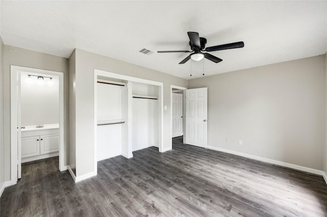 9627 Crooked Wood Ln, Houston, TX 77086 - unfurnished bedroom with a closet, baseboards, and dark wood-type flooring