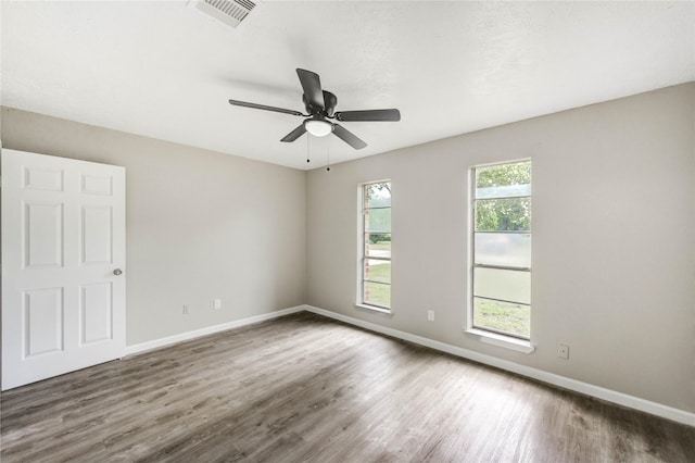 9627 Crooked Wood Ln, Houston, TX 77086 - spare room featuring wood finished floors, baseboards, and a ceiling fan