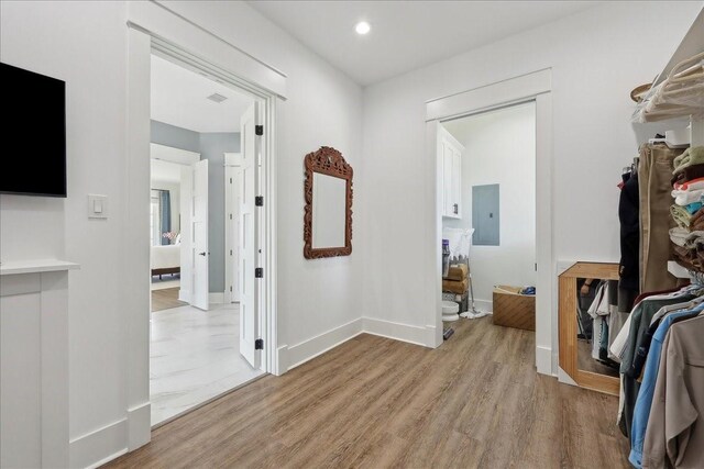 111 Poncho St, Anahuac, TX 77514 - hallway with electric panel, light wood-style flooring, baseboards, and recessed lighting