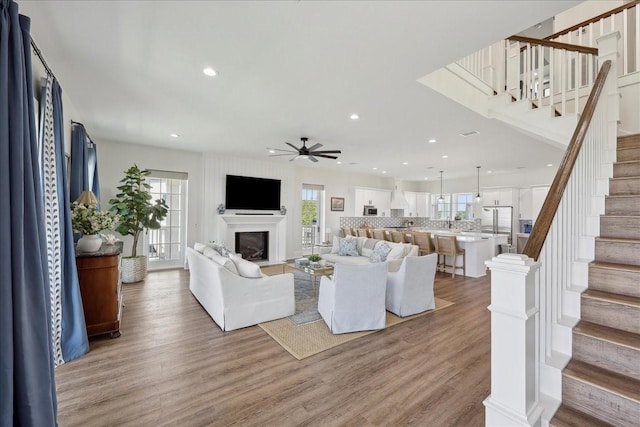 111 Poncho St, Anahuac, TX 77514 - living room with ceiling fan, stairway, a fireplace, recessed lighting, and light wood-style flooring