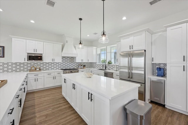 111 Poncho St, Anahuac, TX 77514 - kitchen with stainless steel appliances, recessed lighting, tasteful backsplash, and white cabinets
