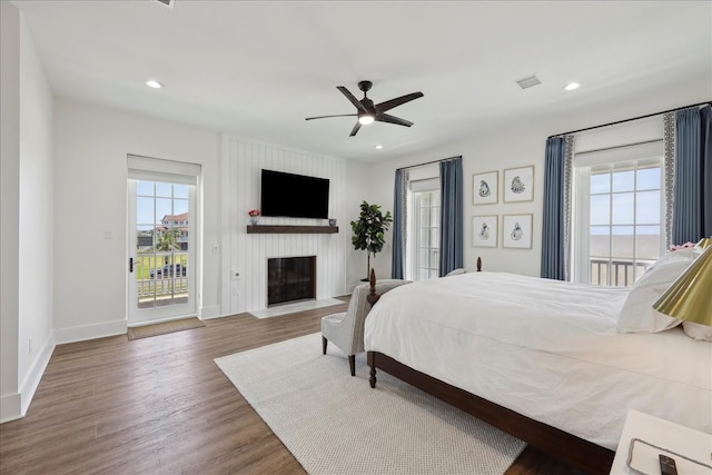 111 Poncho St, Anahuac, TX 77514 - bedroom with access to exterior, multiple windows, wood finished floors, baseboards, and recessed lighting