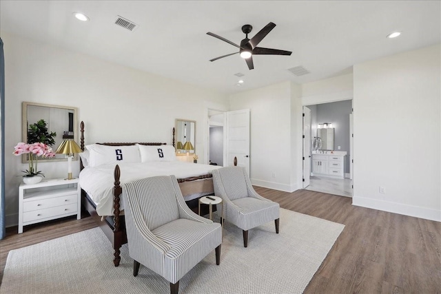 111 Poncho St, Anahuac, TX 77514 - bedroom with wood finished floors, baseboards, connected bathroom, ceiling fan, and recessed lighting