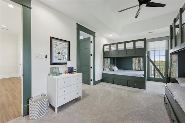 111 Poncho St, Anahuac, TX 77514 - bedroom with recessed lighting, a tray ceiling, baseboards, light carpet, and a ceiling fan