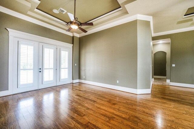 5925 Oak Leaf Ct, Conroe, TX 77304 - spare room featuring a ceiling fan, arched walkways, wood finished floors, ornamental molding, and french doors