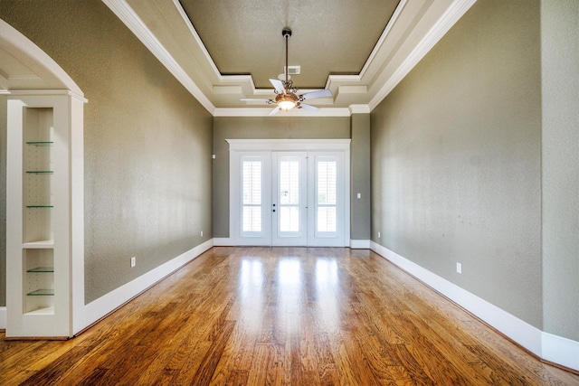 5925 Oak Leaf Ct, Conroe, TX 77304 - empty room featuring ornamental molding, built in features, wood finished floors, a ceiling fan, and french doors
