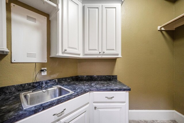 5925 Oak Leaf Ct, Conroe, TX 77304 - kitchen featuring dark countertops and white cabinetry