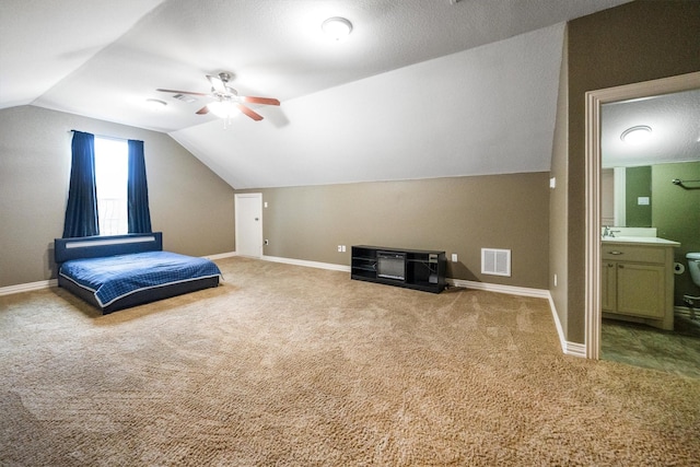 5925 Oak Leaf Ct, Conroe, TX 77304 - unfurnished bedroom featuring carpet flooring, vaulted ceiling, connected bathroom, and ceiling fan