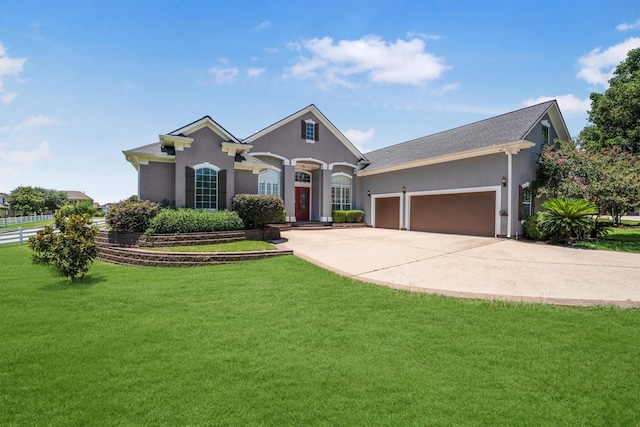 5925 Oak Leaf Ct, Conroe, TX 77304 - view of front of home featuring a garage, a front yard, concrete driveway, and stucco siding