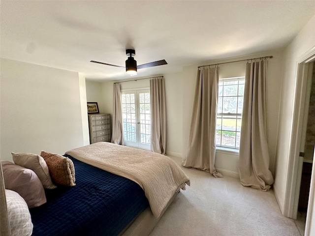 11219 Lorton Dr, Houston, TX 77070 - bedroom featuring multiple windows, light colored carpet, a ceiling fan, and baseboards