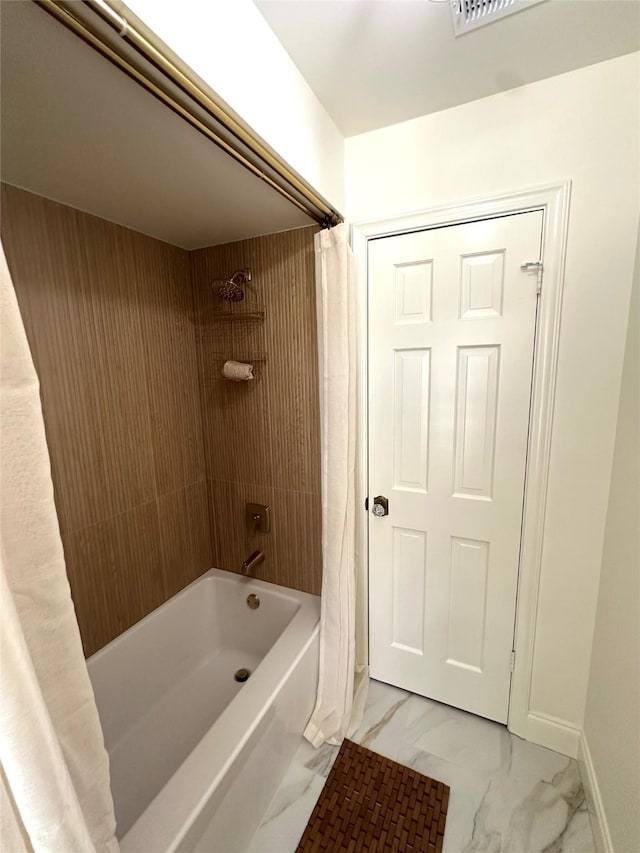 11219 Lorton Dr, Houston, TX 77070 - bathroom featuring marble finish flooring, shower / bath combination with curtain, and baseboards