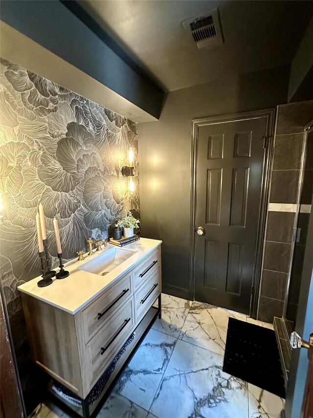 11219 Lorton Dr, Houston, TX 77070 - bathroom with vanity, marble look tile flooring, an enclosed shower, and wallpapered walls