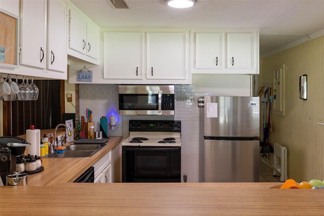 712 Birch Hollow Dr, Somerville, TX 77879 - kitchen featuring stainless steel appliances, a sink, backsplash, light countertops, and white cabinetry