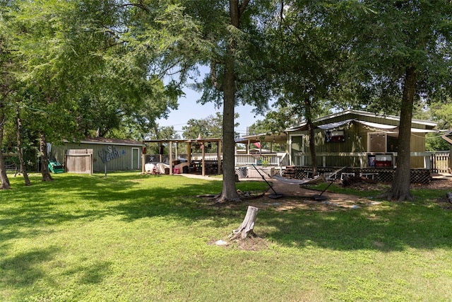 712 Birch Hollow Dr, Somerville, TX 77879 - view of grassy yard with an outbuilding and a deck