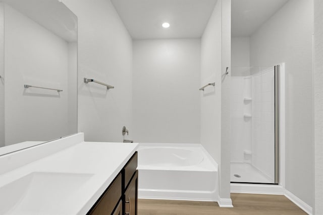 22807 Gentle Shadow Dr, Hockley, TX 77447 - full bathroom with vanity, wood finished floors, a bath, walk in shower, and baseboards