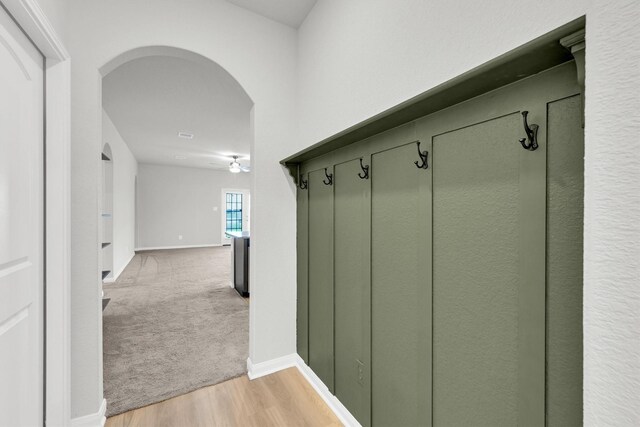 22807 Gentle Shadow Dr, Hockley, TX 77447 - mudroom with arched walkways, light wood-style floors, baseboards, and ceiling fan