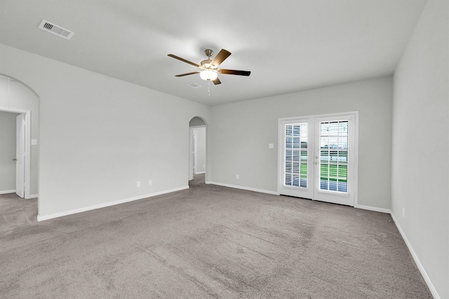 22807 Gentle Shadow Dr, Hockley, TX 77447 - empty room featuring arched walkways, a ceiling fan, carpet floors, and baseboards