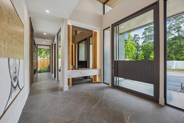 9010 Memorial Dr, Houston, TX 77024 - hallway featuring healthy amount of natural light, stone tile flooring, and recessed lighting