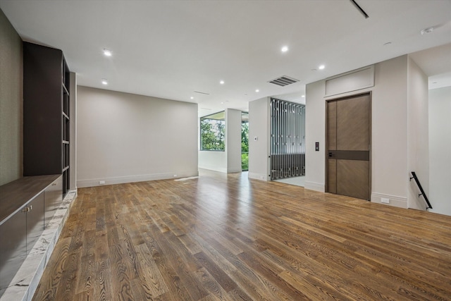9010 Memorial Dr, Houston, TX 77024 - unfurnished living room featuring wood finished floors, recessed lighting, and baseboards