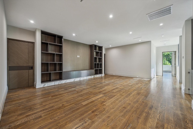 9010 Memorial Dr, Houston, TX 77024 - spare room with wood finished floors, recessed lighting, and baseboards