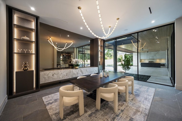9010 Memorial Dr, Houston, TX 77024 - dining space featuring expansive windows, baseboards, recessed lighting, and a chandelier
