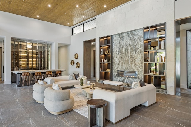 9010 Memorial Dr, Houston, TX 77024 - living area featuring a high ceiling, wooden ceiling, recessed lighting, built in shelves, and a fireplace