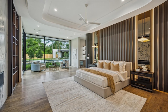 9010 Memorial Dr, Houston, TX 77024 - bedroom with expansive windows, recessed lighting, wood finished floors, and a raised ceiling