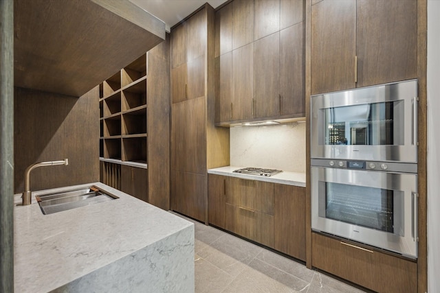 9010 Memorial Dr, Houston, TX 77024 - kitchen featuring light countertops, a sink, modern cabinets, and decorative backsplash