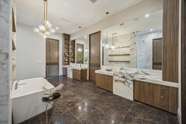 9010 Memorial Dr, Houston, TX 77024 - bathroom featuring marble tiled floors, two vanities, a freestanding bath, built in features, and a chandelier