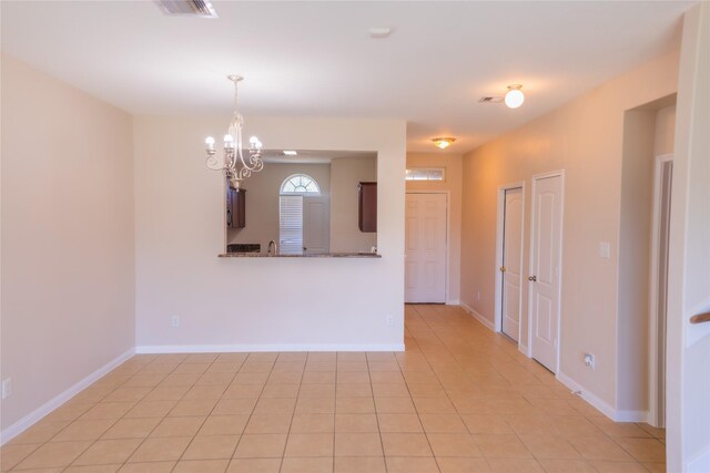 5123 Harbor Palm Dr, Rosenberg, TX 77469 - unfurnished room with a chandelier, baseboards, and light tile patterned floors