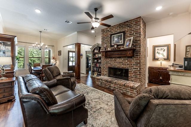1812 Camellia Dr, Huntsville, TX 77340 - living room with wood-type flooring, ceiling fan, a fireplace, a chandelier, and crown molding