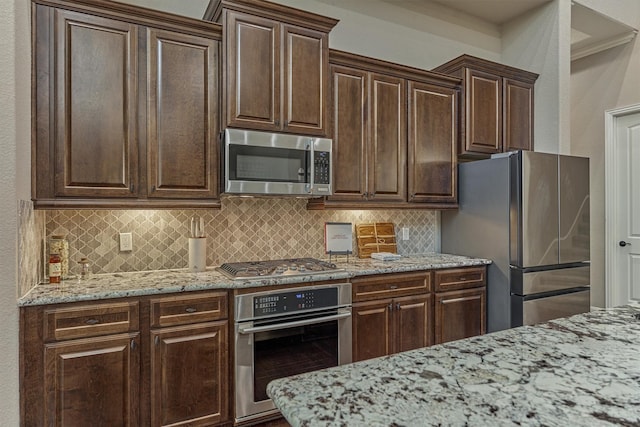 114 Cedar Brush Ct, Montgomery, TX 77316 - kitchen with stainless steel appliances, decorative backsplash, and light stone countertops