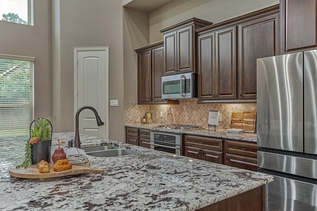 114 Cedar Brush Ct, Montgomery, TX 77316 - kitchen featuring appliances with stainless steel finishes, a sink, healthy amount of natural light, and tasteful backsplash
