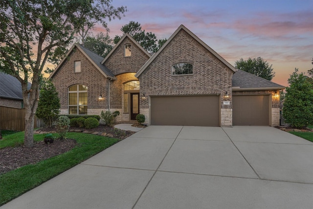 114 Cedar Brush Ct, Montgomery, TX 77316 - french country inspired facade featuring driveway, brick siding, a shingled roof, and an attached garage