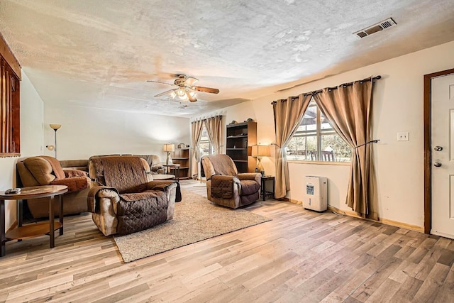 170 Trails End Dr, Cleveland, TX 77328 - living area with light wood finished floors, ceiling fan, and a textured ceiling