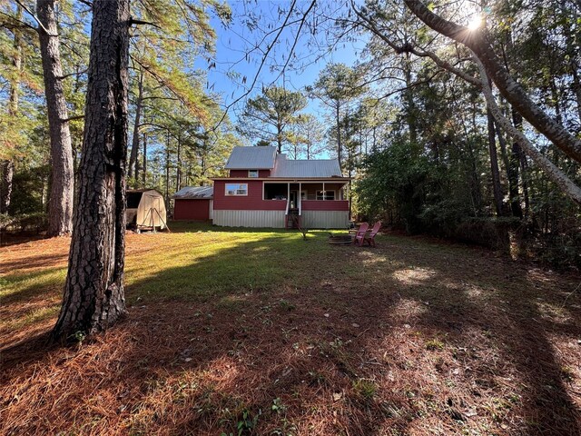 164 Pine Hollow Cv, Brookeland, TX 75931 - view of green lawn featuring an outdoor structure