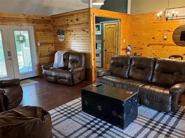 164 Pine Hollow Cv, Brookeland, TX 75931 - living room featuring wood walls, a chandelier, and wood finished floors
