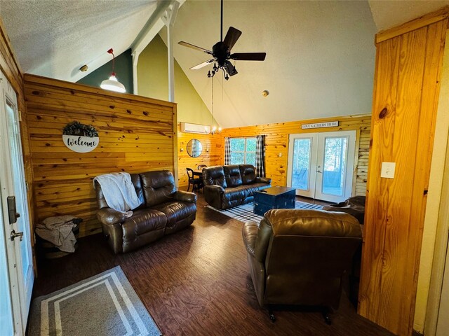 164 Pine Hollow Cv, Brookeland, TX 75931 - living room with wood finished floors, wooden walls, ceiling fan, a wall mounted air conditioner, and french doors