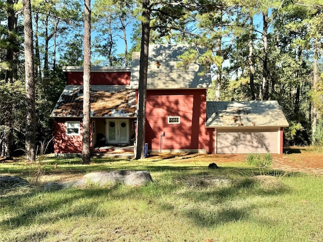 164 Pine Hollow Cv, Brookeland, TX 75931 - view of front of house with an attached garage, french doors, driveway, and a front lawn