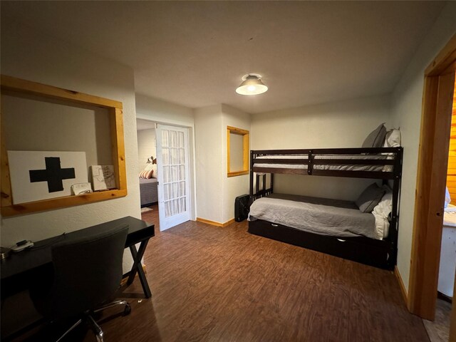 164 Pine Hollow Cv, Brookeland, TX 75931 - bedroom featuring baseboards, dark wood finished floors, and an office area