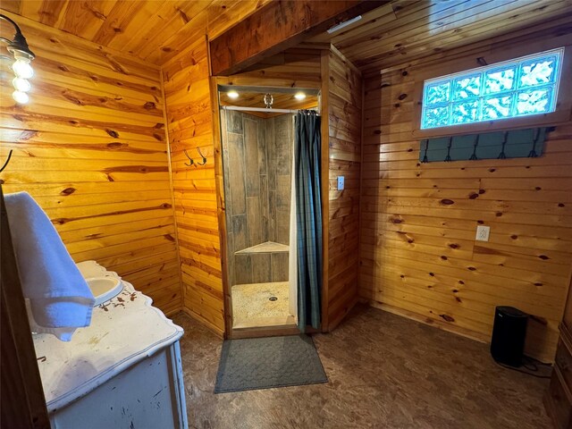 164 Pine Hollow Cv, Brookeland, TX 75931 - full bath featuring wooden walls, a tile shower, wood ceiling, and vanity
