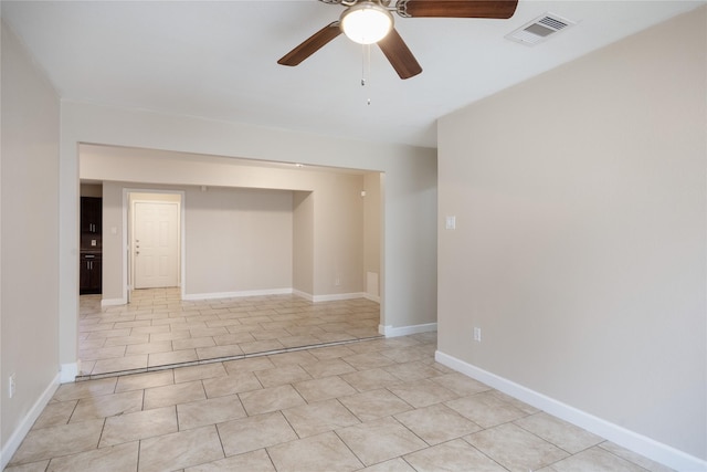 6319 Winfield Rd, Houston, TX 77050 - spare room featuring a ceiling fan, light tile patterned floors, and baseboards