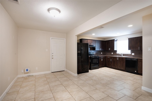 6319 Winfield Rd, Houston, TX 77050 - kitchen featuring black appliances, under cabinet range hood, dark brown cabinetry, a sink, and light tile patterned floors
