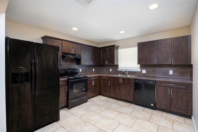 6319 Winfield Rd, Houston, TX 77050 - kitchen with black appliances, under cabinet range hood, dark brown cabinets, tasteful backsplash, and recessed lighting