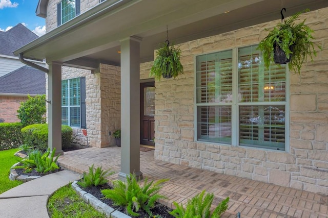 126 S Bluff Creek Cir, The Woodlands, TX 77382 - entrance to property with stone siding and a porch