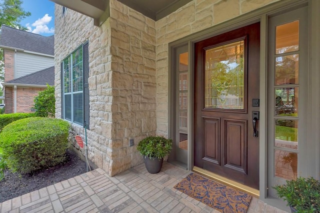 126 S Bluff Creek Cir, The Woodlands, TX 77382 - doorway to property with stone siding and a porch