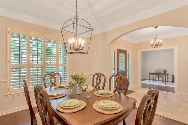 126 S Bluff Creek Cir, The Woodlands, TX 77382 - dining room with a chandelier, arched walkways, and crown molding