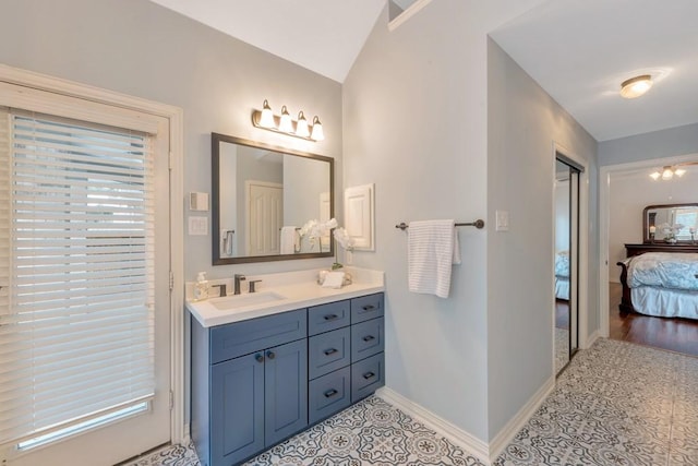 126 S Bluff Creek Cir, The Woodlands, TX 77382 - ensuite bathroom featuring vanity, lofted ceiling, and tile patterned floors