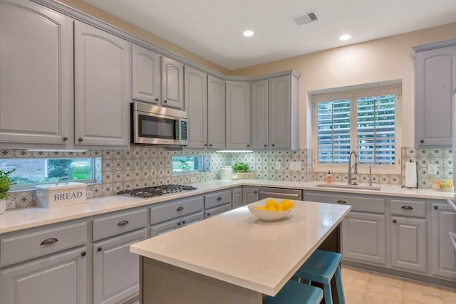 126 S Bluff Creek Cir, The Woodlands, TX 77382 - kitchen with appliances with stainless steel finishes, gray cabinets, decorative backsplash, healthy amount of natural light, and recessed lighting