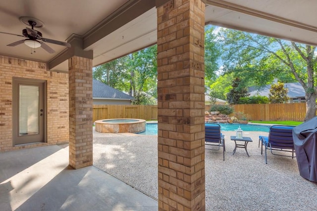 126 S Bluff Creek Cir, The Woodlands, TX 77382 - fenced backyard featuring a ceiling fan, a patio area, and an in-ground hot tub